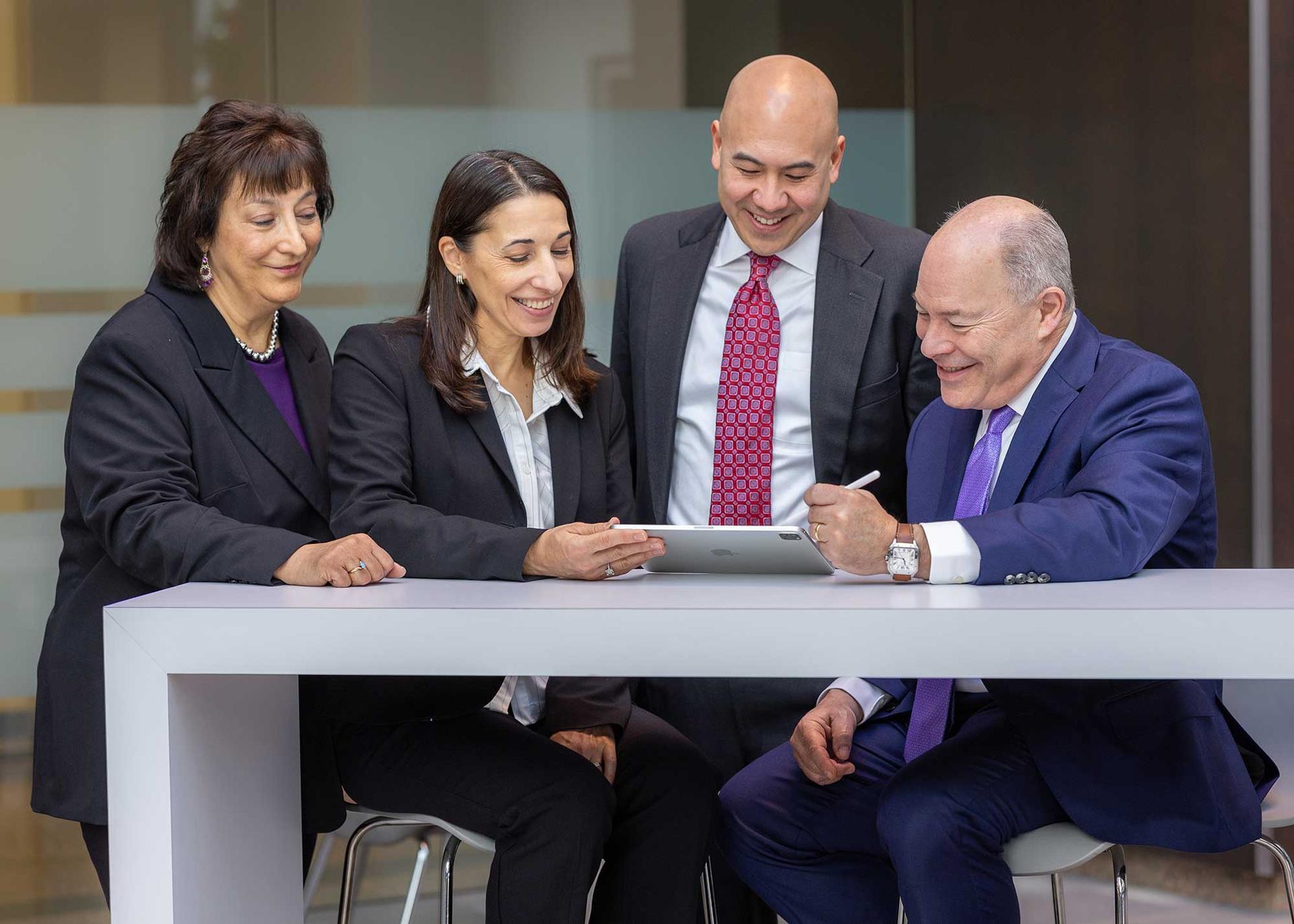 The Neuman team looking over files